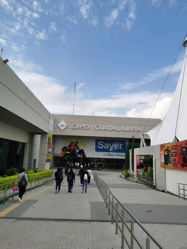 Expo Guadalajara building with people walking in front on a clear day